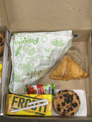 Snackbox with sandwich samosa muffin frooti